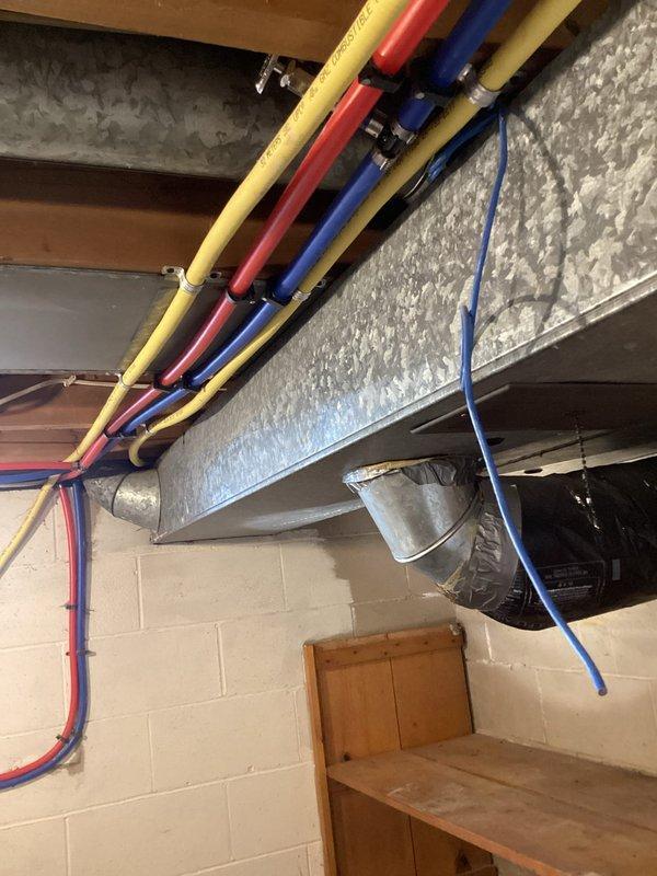 # Plumbing Service Report

Responded to service call for laundry room plumbing installation and water treatment consultation. Assessed existing utility space to determine requirements for new washer and dryer water supply lines. Evaluated current plumbing infrastructure in basement area, including access points through cinder block walls and proximity to existing HVAC ductwork and refrigerant lines. Documented site conditions via photographs showing available workspace, wall penetrations, and mechanical room layout to develop comprehensive estimate for laundry hookup installation. Discussed water softener system options with customer based on household needs and existing plumbing configuration. Provided detailed estimate for complete laundry room water line installation including hot and cold supply connections and drain provisions.