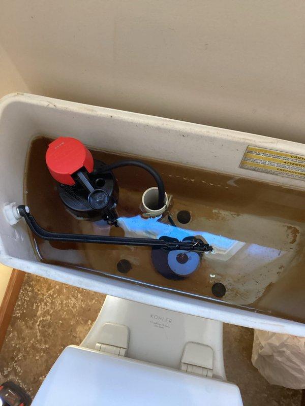 River Falls, WI - Responded to customer report of intermittent banging noise occurring approximately once per week when toilet is flushed. Upon inspection, could not recreate the reported problem during service window. Based on frequency pattern and system evaluation, determined noise likely caused by water softener regeneration cycle introducing air into water supply lines. Rebuilt toilet fill valve assembly as preventative measure to eliminate potential contributing factors, as existing fill valve showed signs of wear and mineral deposit accumulation in tank. Documented tank condition with photographs showing internal components and water quality issues.