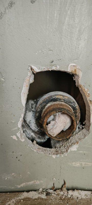 Responded to bathroom sink drain connection issue following vanity replacement. Upon arrival, found heavily corroded 1-1/4" galvanized drain pipe protruding from wall with male threads that would not accept standard trap connections. Previous installation had been improperly configured with PVC connected directly to the deteriorated galvanized pipe. Installed 1-1/4" x 1-1/2" Mission band coupling to adapt the corroded galvanized stub-out, then connected trap adapter and new 1-1/4" P-trap assembly. Completed installation of customer-supplied drain assembly to vanity sink. Tested system for proper drainage and verified no leaks at all connection points.