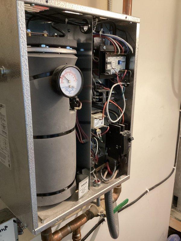 Inspected electric boiler system with reported issues in the in-floor glycol-based heating. Verified heating elements are operational and pump is circulating properly, but discovered closed valves on the infloor manifold preventing proper flow. Previous service noted low pressure concerns, but current inspection confirmed system functionality with proper valve positioning.