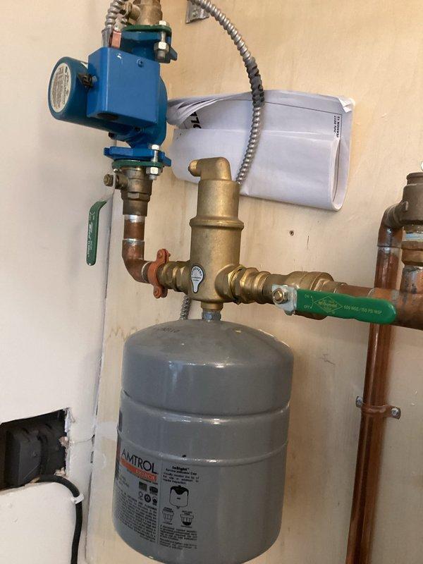 Inspected electric boiler system with reported issues in the in-floor glycol-based heating. Verified heating elements are operational and pump is circulating properly, but discovered closed valves on the infloor manifold preventing proper flow. Previous service noted low pressure concerns, but current inspection confirmed system functionality with proper valve positioning.