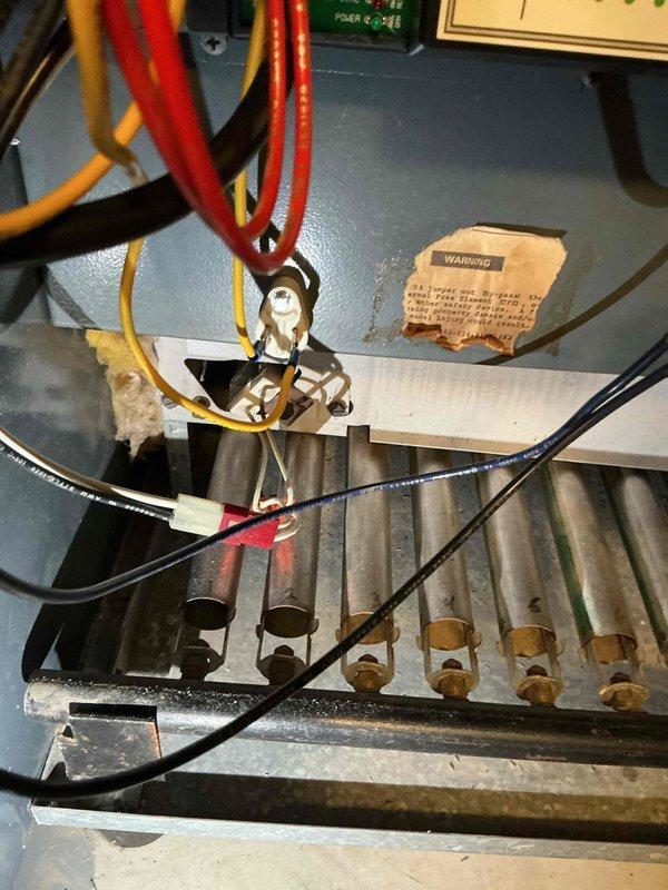 Responded to service call for boiler failure caused by a pressure valve malfunction that resulted in flooding and steam damage. Replaced high limit control and roll out switch to restore system safety functionality. Documented repair with photos of heat exchanger assembly and burner tubes with associated control wiring.