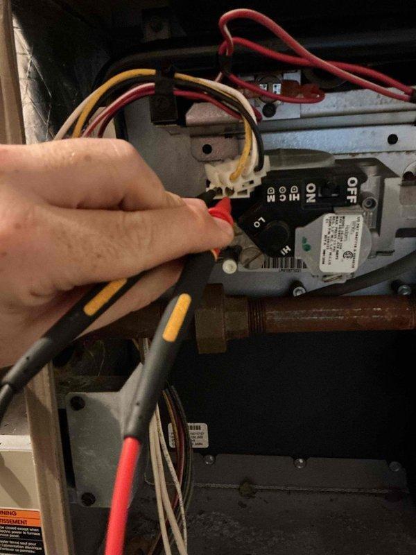 Responded to no heat complaint on 7-year-old Luxaire furnace. Diagnosed system with only one burner igniting during heat call. Upon inspection of burner assembly, found low fire side of gas valve coil was open. Attempted to clean orifices but gas valve subsequently failed to operate. Recommended replacement of gas valve and burner assembly or furnace replacement as alternative solution due to deteriorated condition of burner components.