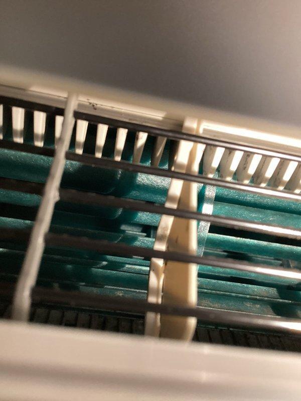 Performed follow-up inspection after recent mini split deep cleaning to address customer's concerns about black tar-like particles staining carpet. Observed minor debris on floor consistent with normal post-cleaning residue. Documented condition of evaporator coils and surrounding area with photos. Advised customer that similar minor debris may occur with future cleanings due to normal system purging process.