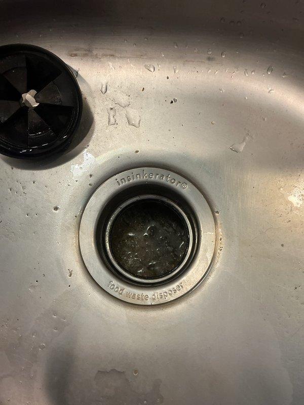 Roseville, MN - Responded to kitchen sink clog related to InSinkErator food waste disposer. Cleared blockage using snake method and repositioned saddle valve to top position to improve drainage function and prevent future backups.