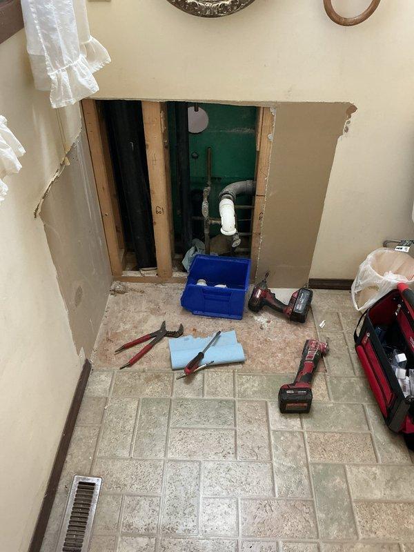 Responded to emergency call for shower valve leaking extensively into bathroom and basement. Upon inspection, discovered customer's DIY cartridge replacement attempt resulted in faucet broken off inside wall. Accessed plumbing through wall cutout, removed pedestal for proper access, and replaced damaged shower valve and trim assembly to restore proper functionality and eliminate leaks.