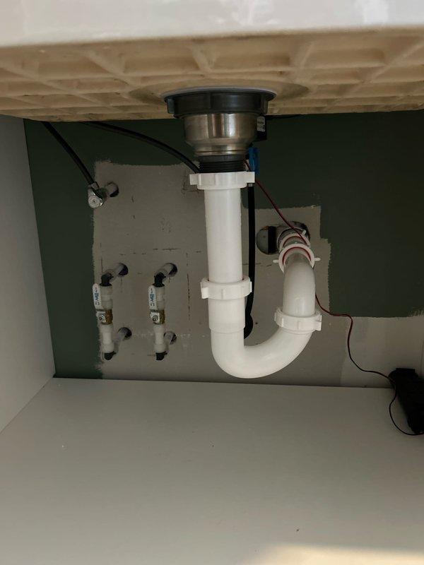 Completed installation of customer-supplied sink, faucet, basket strainer and P-trap assembly in laundry room. Properly connected new fixtures to existing plumbing lines and verified operation with no leaks.