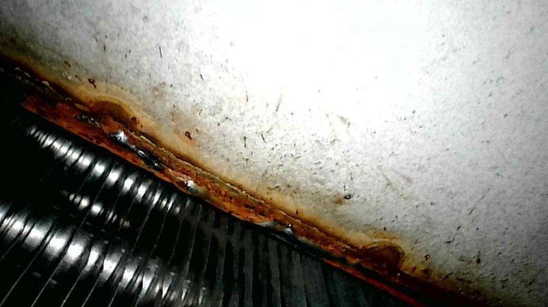 Responded to no heat call for 10+ year old FA furnace. Diagnosed clogged condensate drain line causing system shutdown. Cleaned drain line and inspected heat exchanger, noting moderate corrosion and rust formation. System restored to proper operation after service.