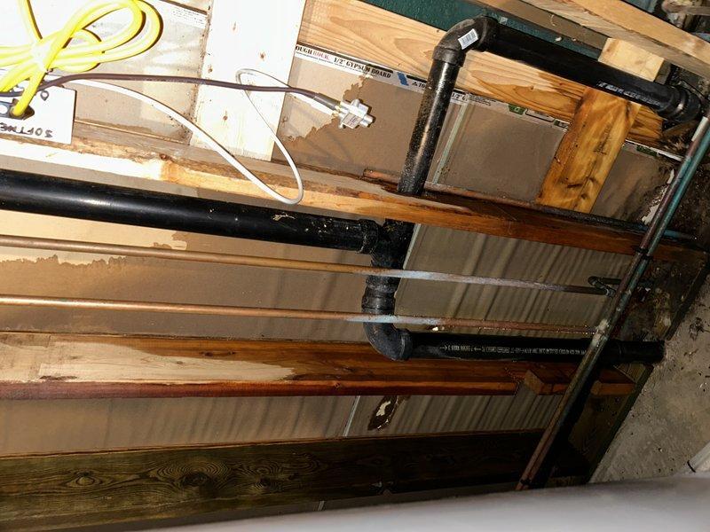 Responded to service call for reported toilet leak. Upon inspection, determined issue was not with toilet but identified pinhole leak in main water line above water meter that was spraying at wall. Completed repair by replacing affected section of pipe and installing new ball valve.