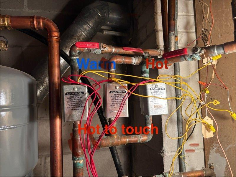 Diagnosed heating issue with a 4-year-old boiler system where upstairs radiators were cold despite system operation. Inspection revealed functional zone valves with hot piping below valves but only warm piping above, suggesting air trapped in the system. Radiators lacked bleeder valves for proper air removal. Scheduled return visit to implement air removal using pump system and discuss installation of bleeder valves with homeowner to restore proper heat distribution throughout all zones.