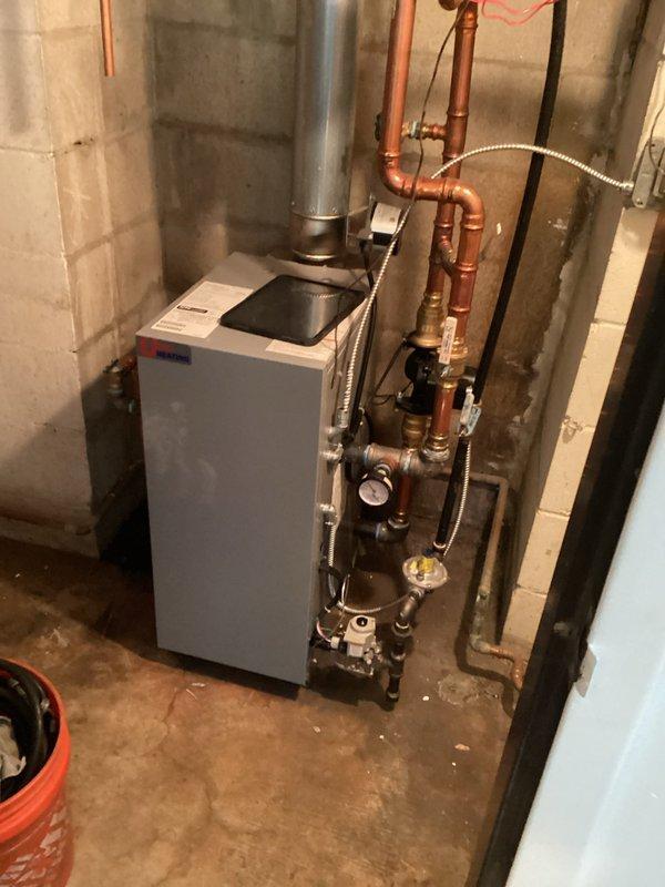 Diagnosed heating issue where bedroom and living room areas were not heating properly. Inspected boiler components including heat exchanger, burners, circulator pump, and zone valves. Purged air from the system and determined no water flow through bedroom zone, likely due to frozen lines. Recommended using space heaters directed at radiators to gradually thaw affected lines, with follow-up service after thawing is complete.