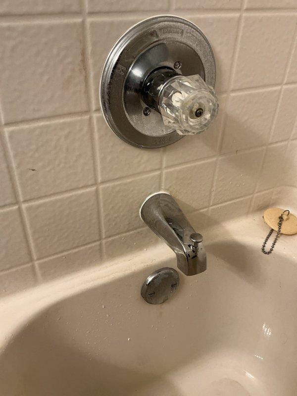 Responded to leak issue where water was penetrating from upstairs bathroom into garage ceiling. Inspection revealed improperly installed tub spout by previous contractor. Remediated by installing new copper pipe extension through wall and replacing tub spout (customer-supplied) to ensure proper connection and prevent further leakage.