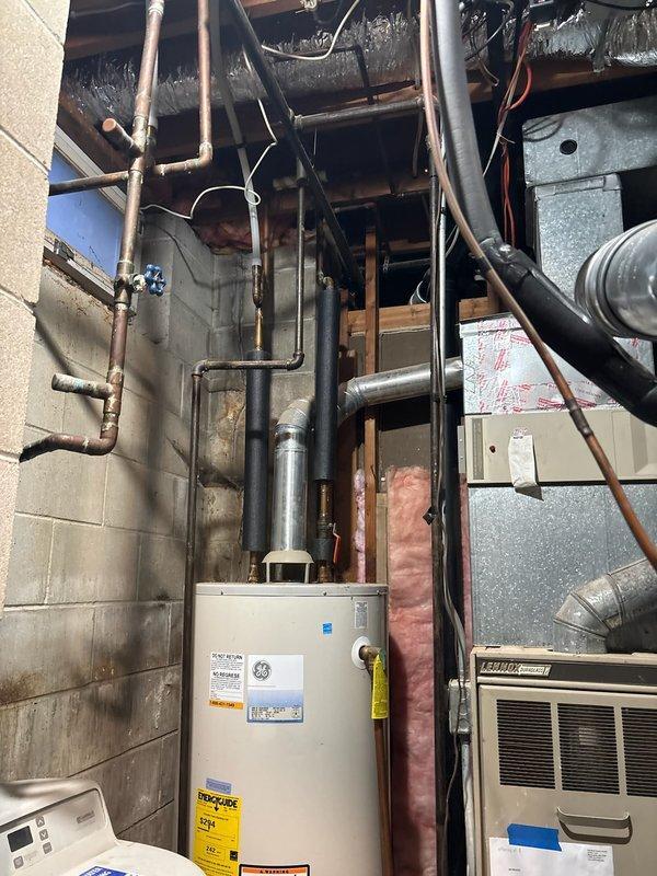 Minnetonka, MN - Successfully replaced an aging 16-year-old 50-gallon LP water heater with a new 75-gallon unit to address customer's complaint of insufficient hot water supply. Installation included connecting to existing copper plumbing and ventilation system in the mechanical room, ensuring proper venting through the black exhaust piping.