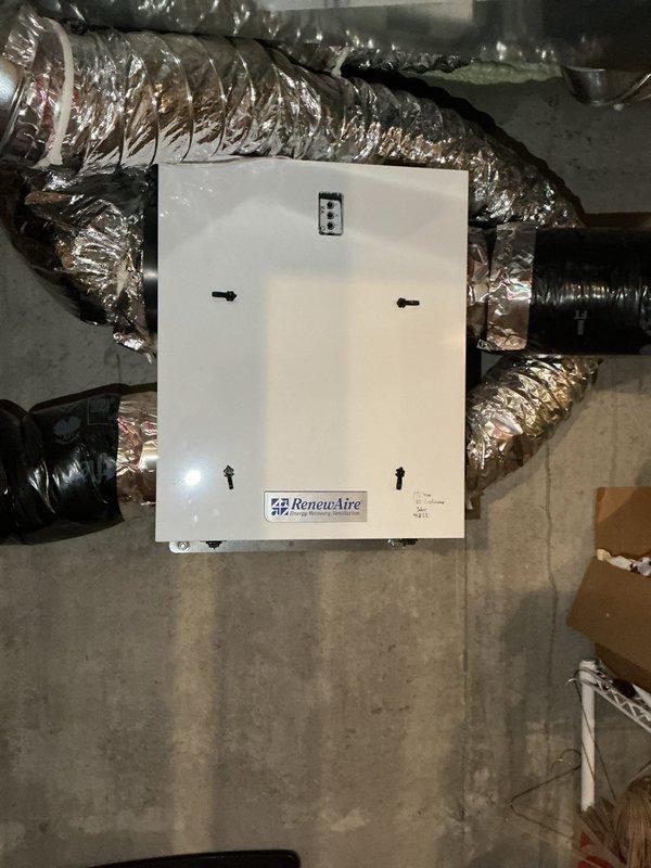 Responded to no hot water complaint for 4-year-old water heater (potentially under manufacturer warranty). Diagnosed issue as tripped GFI outlet affecting system operation. Restored hot water service by resetting GFI. Inspected ventilation system and water treatment equipment, noting proper installation of RenewAire unit with connected flexible metallic ducts and functional water filtration system with control panel.