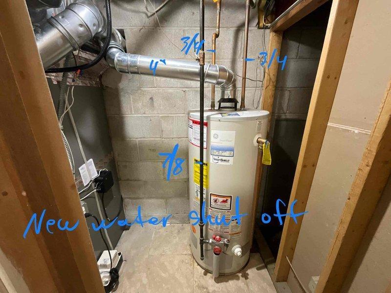 Responded to water heater emergency with active leak from bottom of unit. Performed complete water heater replacement in basement utility area, installing new residential water heater with proper venting connections. Upgraded plumbing system components including new water shut-off valve for improved accessibility and code compliance, new thermal expansion tank to protect against pressure buildup, and new disaster pan for leak protection. Installed new PEX supply line connections with appropriate fittings. All copper piping connections secured at top of unit with proper valve configuration. System tested for proper operation and verified no leaks at connections or base of new unit.