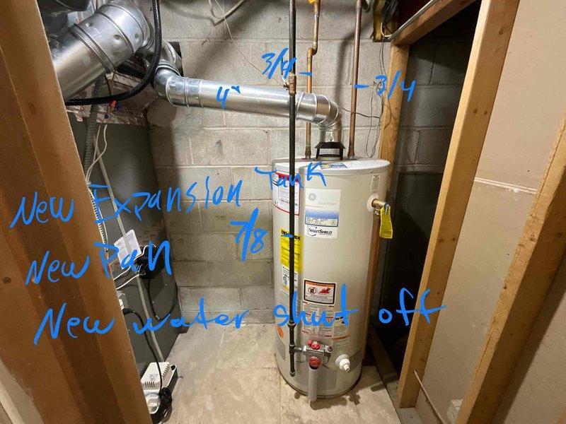 Responded to water heater emergency with active leak from bottom of unit. Performed complete water heater replacement in basement utility area, installing new residential water heater with proper venting connections. Upgraded plumbing system components including new water shut-off valve for improved accessibility and code compliance, new thermal expansion tank to protect against pressure buildup, and new disaster pan for leak protection. Installed new PEX supply line connections with appropriate fittings. All copper piping connections secured at top of unit with proper valve configuration. System tested for proper operation and verified no leaks at connections or base of new unit.