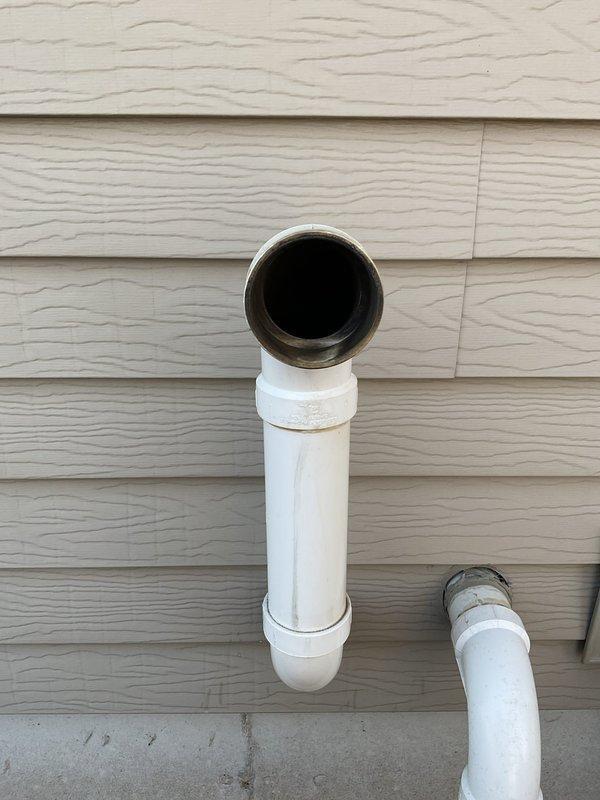 Responded to no heat call and found LP furnace had run out of fuel, resulting in severe soot buildup throughout the system including flue pipe and secondary garage heater. Upon inspection, discovered heat exchanger leak with sooted condensate visible on floor beneath unit. Documented conditions with photos of gauge and exterior PVC vent terminations, advised of necessary replacement, and scheduled follow-up consultation.