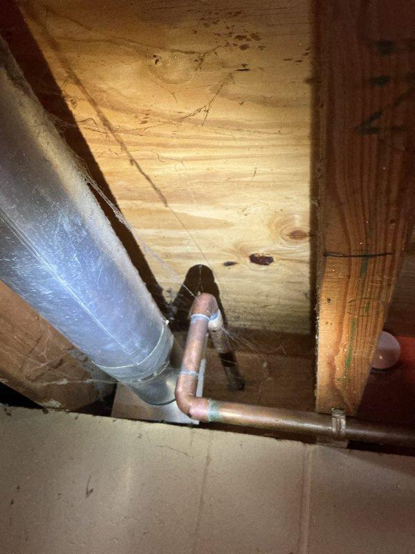 Replaced defective exterior hose bib (spigot) and faulty shower valve cartridge. The outdoor copper spigot mounted on the building's exterior wall was removed and replaced with a new frost-free unit, and the interior shower valve cartridge was replaced to restore proper water flow and temperature control.