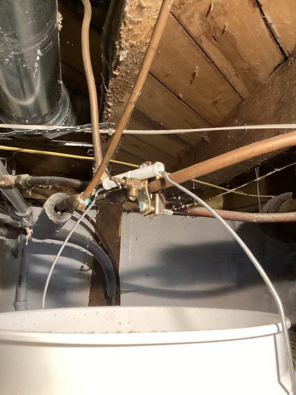 Wilson, WI - Responded to service call for a leaking piercing valve on a 3/8" hot water line that was failing to shut off after HVAC contractor removed an old humidifier. Removed the defective piercing valve and repaired the damaged section of copper piping using a SharkBite coupling to restore proper system operation.
