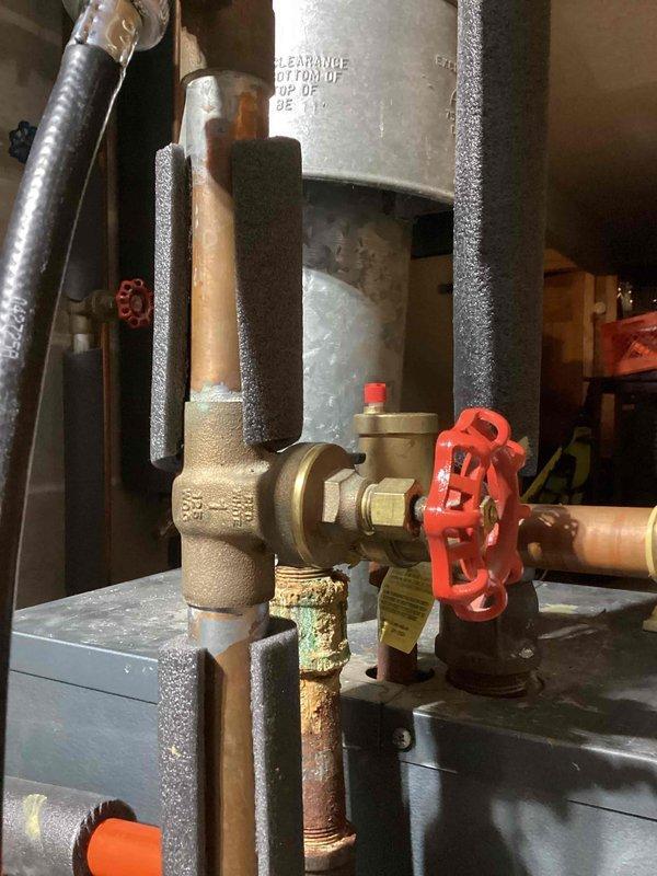 Responded to a return service call to install a relief valve on customer's boiler system. Successfully installed the relief valve and performed a complete system bleed, but noted the boiler was still overheating due to poor water circulation. Inspection revealed the circulator pump was operational but ineffective, with a potentially defective ball valve above the pump that may have a broken shaft preventing proper opening/closing. Recommended further diagnosis by a boiler specialist.