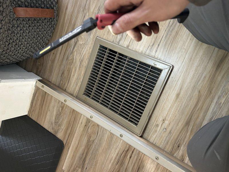 Responded to a no-heat call for an 80's era furnace blowing cold air. Upon arrival, system was locked out due to overheating with supply air temperatures approaching 150°. Diagnosed severely restricted airflow with almost 1" WC static pressure on return side and minimal static on supply side. Found only two functional returns throughout home, multiple closed vents, and heavy dust accumulation in ductwork. Reset system, opened basement vents, verified all supplies were open, and inspected burners (found crusty). Noted system using cooling wire on blower for heating due to furnace running hot. Verified proper gas pressure, correct orifice, and functioning blower capacitor.