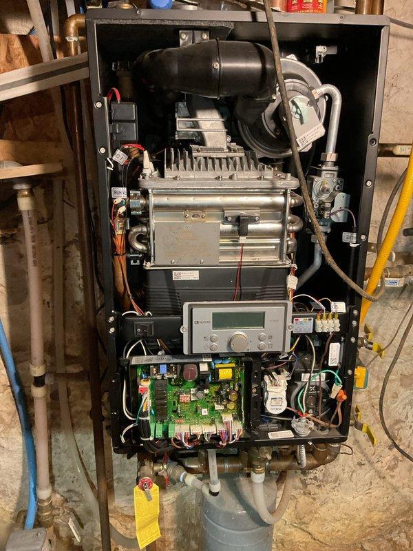 Responded to call for RS12-4 condensing boiler (LP, 4 years old) displaying overheating code and shutting down after only 10 seconds of operation. Inspection revealed blocked combustion air intake with debris and a bumblebee obstructing proper airflow. Preliminary diagnosis indicates possible scaling on heat exchanger per manufacturer's technical information. Unit was powered off for safety as heat exchanger temperature was excessively high. Return visit scheduled to perform full diagnosis with manufacturer technical support and determine if descaling procedure is required to restore proper operation.