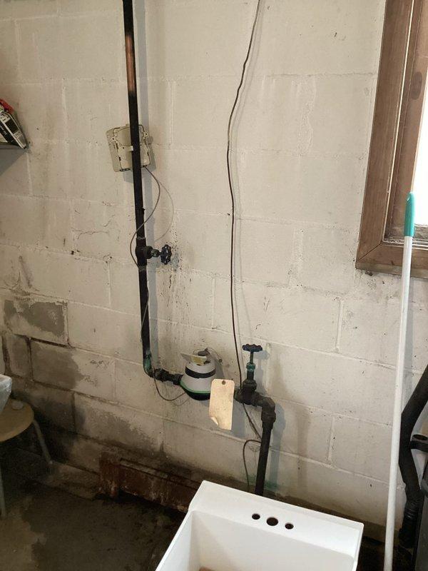 Resolved multiple water leaks in multi-unit building including replacement of main shut-off valve after the meter which was actively dripping. Additionally replaced damaged laundry room sink along with associated dripping valves and installed new washing machine supply valve to address ongoing moisture issues evident in utility area.