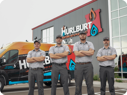 Hurlburt employees posing in front of company building and van