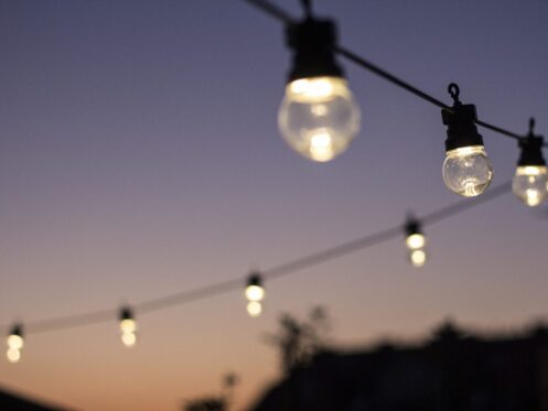Outdoor string lights hanging in line.