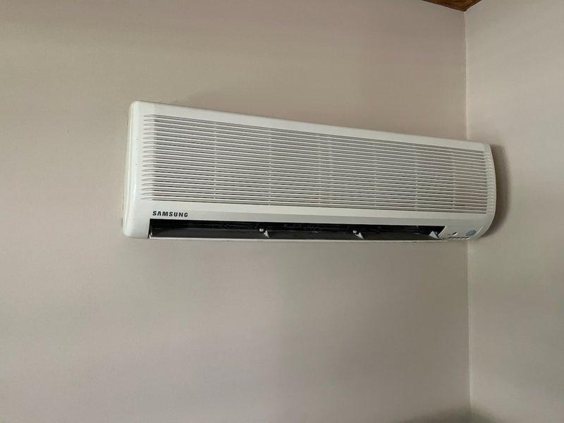 Responded to no cooling complaint for aging Samsung mini split system. Diagnostic testing revealed complete power loss to the unit, which was also noted to be extremely dirty. Scheduled follow-up appointments for both an electrician to inspect the electrical box and a sales appointment for Tuesday to address the system's condition.