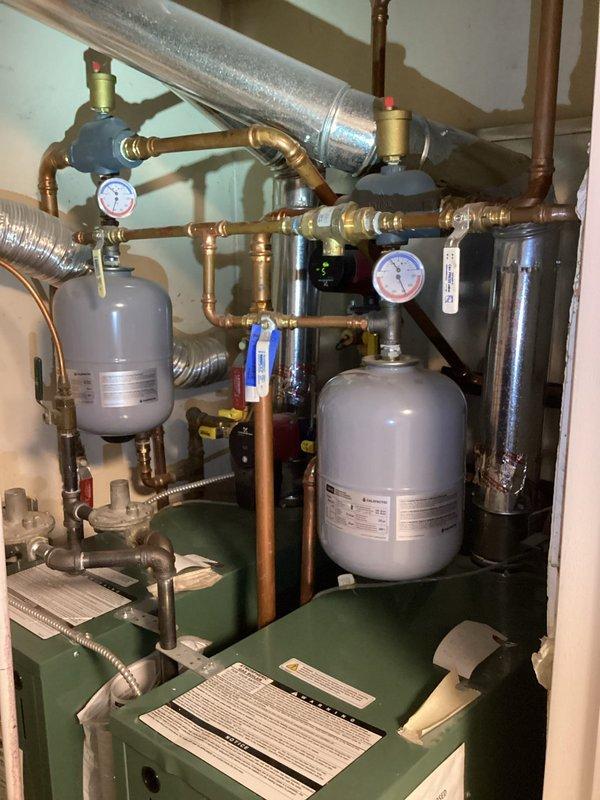Completed water heater estimate for a duplex with two leaking 40-gallon gas water heaters sharing a single exhaust vent (non-code compliant). Recommended replacement of both atmospheric water heaters with appropriate units for the confined space. Also recommended installation of water softeners to address municipal water quality issues (high magnesium) and carbon filters to improve taste and odor.
