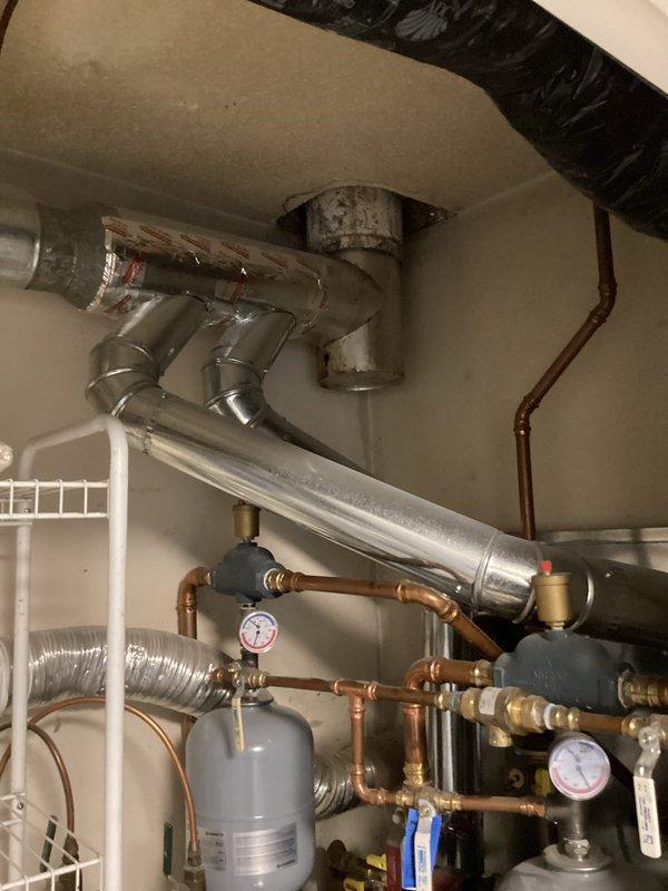 Completed water heater estimate for a duplex with two leaking 40-gallon gas water heaters sharing a single exhaust vent (non-code compliant). Recommended replacement of both atmospheric water heaters with appropriate units for the confined space. Also recommended installation of water softeners to address municipal water quality issues (high magnesium) and carbon filters to improve taste and odor.