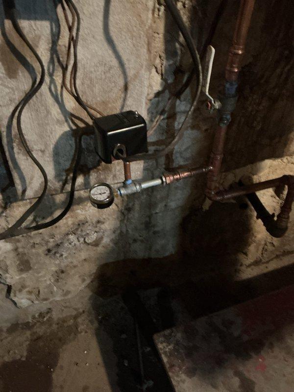 Responded to a call regarding inconsistent water pressure issues in basement plumbing system. Upon inspection, found significant sediment buildup in the 5-year-old pressure switch component of the Wells system. Removed old switch and installed new 4060 pressure switch to restore proper system function and consistent water pressure.
