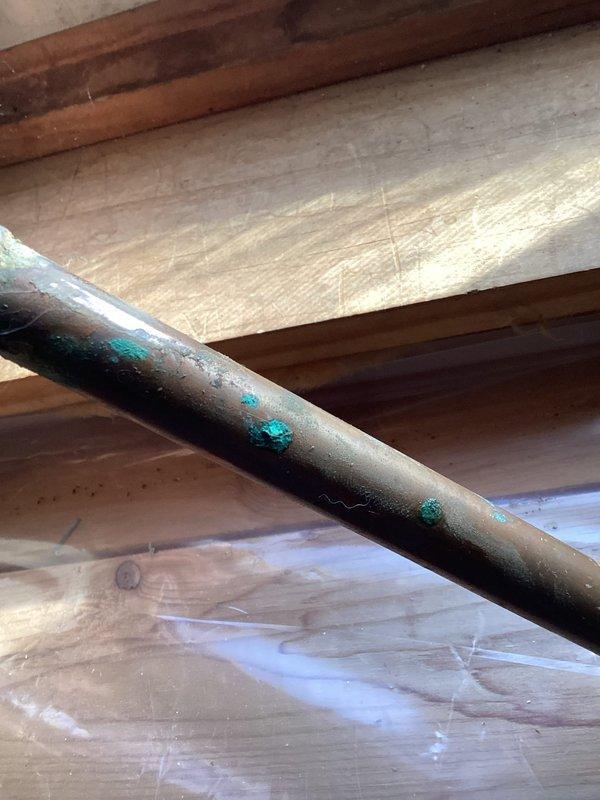 Responded to service call for a water leak. Upon inspection, located a pin hole leak in copper water piping with visible green corrosion, indicating deterioration. Successfully replaced the damaged section of water pipe to resolve the issue.