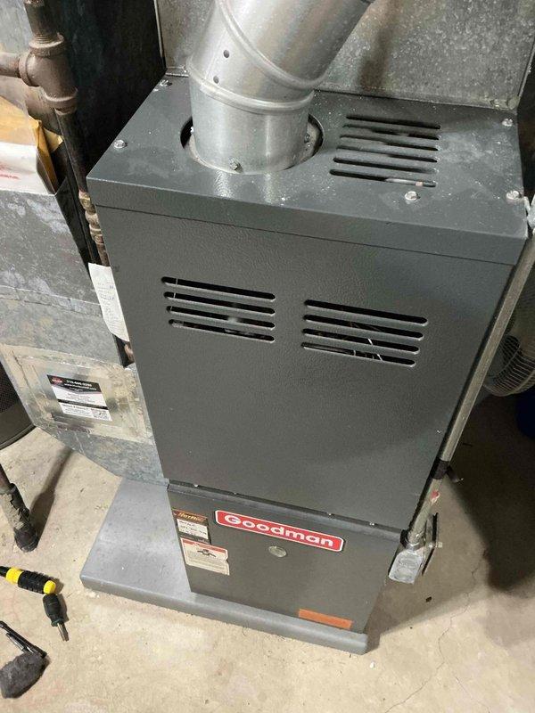 Responded to no heat call for 22-year-old Goodman furnace. Diagnosed issue with draft motor operating but failing to engage pressure switch for ignition sequence. Temporarily restored operation by tapping pressure switch. Verified draft port and pressure switch port were clear of debris. Identified and secured melting wire that was contacting hot draft motor housing. Noted potential heat exchanger crack but could not confirm with certainty; customer informed of associated risks and opted to schedule consultation for furnace replacement.