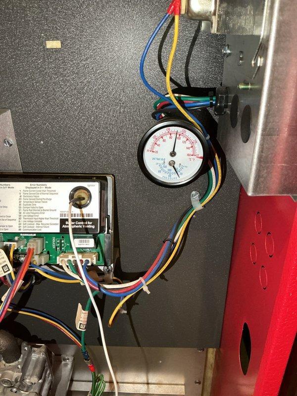 Upon arrival, found house temperature below setpoint despite boiler cycling normally. Discovered partially closed valve on return side above pump causing restricted water flow, which led to system overheating and short cycling. Opened valve to restore proper circulation. Also identified plugged backflow preventer preventing system from automatically adding water when needed. Verified boiler (GL Series AWR105ENS72PSU, 105,000 BTU/hr input) is fully operational after adjustments.