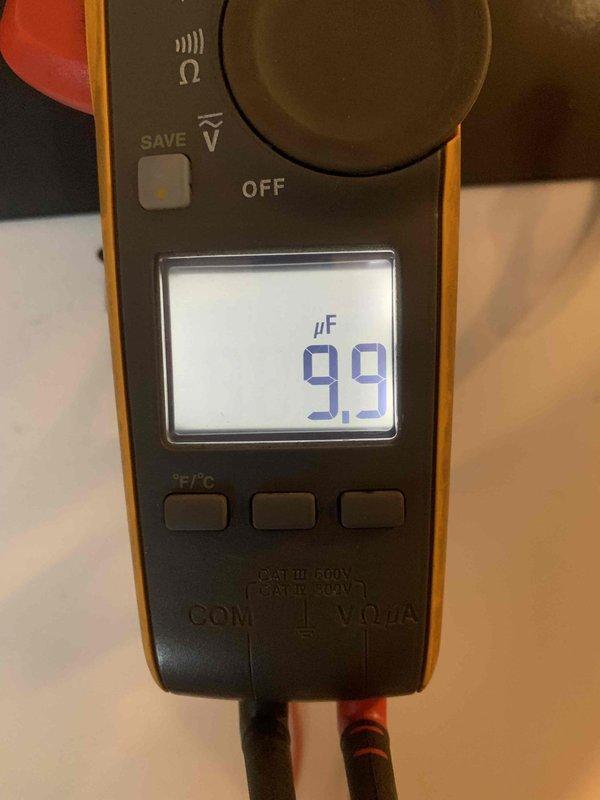 Diagnosed garage heater showing high temperature limit error code. Investigation revealed seized blower fan motor, confirmed with multimeter testing showing capacitance reading of 9.9 μF. Recommended motor replacement and scheduled comfort advisor for follow-up.
