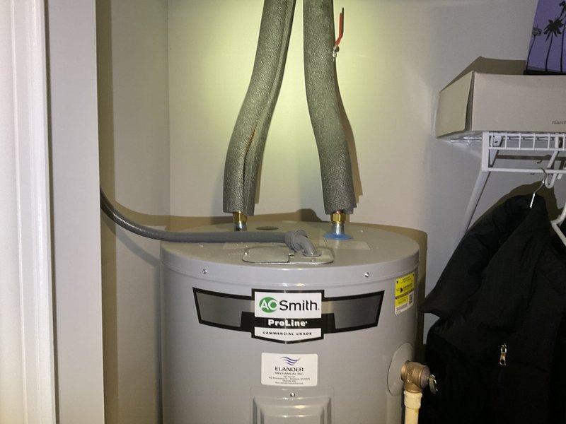 Diagnosed electric water heater with recurring tripping issue; found failed lower heating element and deteriorated upper element. Replaced both elements and thermostats, performed maintenance by vacuuming sediment buildup from tank bottom and flushing unit to restore proper operation.