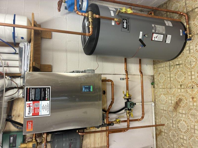 Responded to no hot water complaint after recent installation. Upon arrival, system was operating normally at correct temperature. Customer had previously reset power switches which likely resolved the intermittent heating issue. Inspected HTC water heater and associated components - all functioning properly with good connections. Modified exterior exhaust pipe to improve venting and ensure proper system operation.