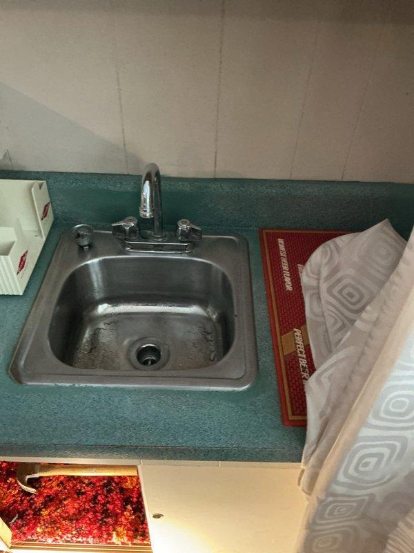 Performed comprehensive plumbing inspection with focus on faucet systems. Identified and cleared debris blockage at fitting where washer and shower drain lines connect, which was causing shower drain backup during washer operation. Augered drain through laundry room standpipe to ensure proper flow. Inspected stainless steel kitchen sink installation and shower stall faucet assembly for proper function.