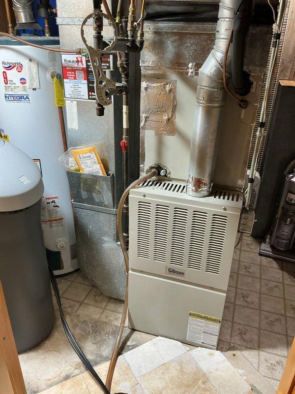 Diagnosed water softener experiencing salt bridging issue (salt dam), preventing proper regeneration cycles. Inspected adjacent Richmond Integra water heater and Gibson HVAC system to ensure no related issues. Scheduled follow-up appointment to perform complete service on water softener and provide customer with water heater replacement options.