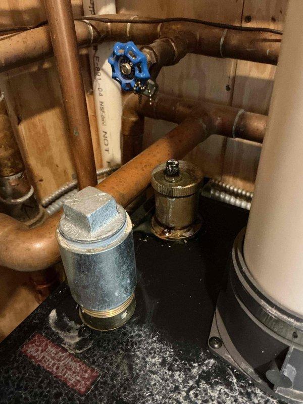 Responded to no-heat emergency call where system displayed error code. Diagnosed issues with hydronic heating system including visible water leak at blue valve connection and rust streaks on pressure tank. Attempted temporary repair to restore heat; system requires comprehensive service including replacement of circulator pump and remediation of copper pipe corrosion at multiple connection points.