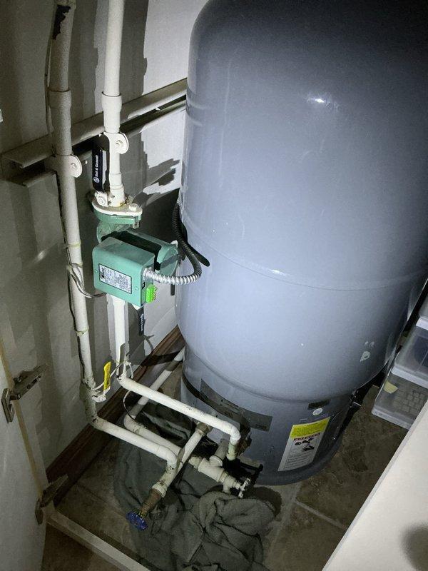 Completed extensive boiler system repairs including replacement of a leaking cartridge air eliminator on the boiler, removal and replacement of a leaking air separator on the primary loop, and installation of a new circulator pump for domestic hot water due to grinding in the previous unit. System was thoroughly flushed across all loops to address discolored water with odor, followed by Fernox treatment, air purging, and operational verification; noted non-functioning Taco pump at indirect tank requiring future replacement.