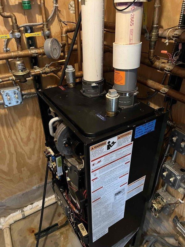 Completed extensive boiler system repairs including replacement of a leaking cartridge air eliminator on the boiler, removal and replacement of a leaking air separator on the primary loop, and installation of a new circulator pump for domestic hot water due to grinding in the previous unit. System was thoroughly flushed across all loops to address discolored water with odor, followed by Fernox treatment, air purging, and operational verification; noted non-functioning Taco pump at indirect tank requiring future replacement.