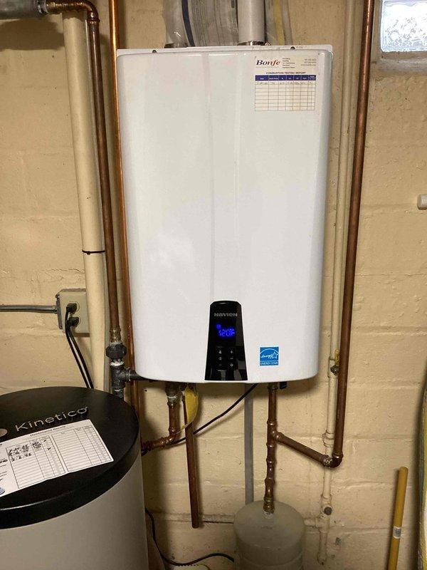 Responded to service call for Banje tankless water heater displaying error code E110 with no hot water output. Diagnosed issue as screen obstruction; cleared accumulated debris from system which restored normal operation. Unit now functioning properly with temperature set at 125°F.