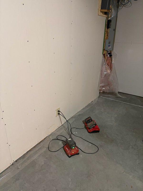 Completed assessment of unfinished basement area for sump pump discharge pipe installation. Verified existing setup where another company (Groundworks) is installing the sump pump, while our service is required specifically for PVC discharge piping. Confirmed need to verify permit status before proceeding with installation.