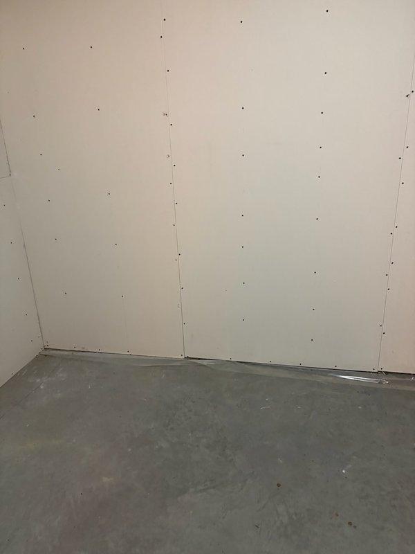 Completed assessment of unfinished basement area for sump pump discharge pipe installation. Verified existing setup where another company (Groundworks) is installing the sump pump, while our service is required specifically for PVC discharge piping. Confirmed need to verify permit status before proceeding with installation.