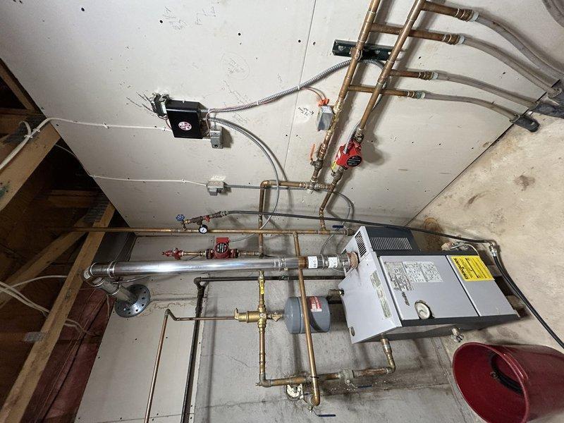 Completed 3-hour repair service involving replacement of a 1/2-1" three-way zone valve for basement heating system. Installed new zone valve and two new thermostats, with specific instruction to customer regarding gradual temperature adjustment (1° at a time) for basement thermostat to prevent overheating. Successfully tested floor heating system and upstairs zones, confirming proper operation of all components.