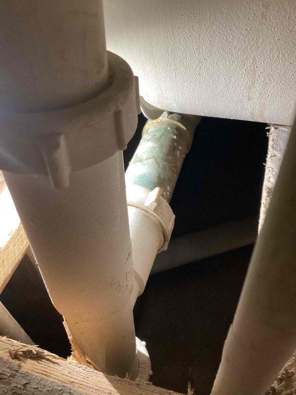 Diagnosed water leak issue originating from bathroom tub. Inspection revealed faulty toe kick slider with deteriorated gasket causing water to seep through to lower level bathroom ceiling when tub was clogged with standing water. Documented plumbing system with photos showing PVC drainage pipes and corroded copper supply line. Provided estimate for replacement of toe kick and arm components to resolve the leak.