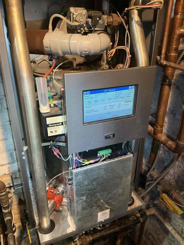 Responded to service call for a leaking boiler. Inspected F/T system showing proper temperature readings (inlet 165°F, outlet 181°F, stack 175°F) with DHW at 113°F. Adjusted settings on the FTT-Console to resolve the leaking issue, confirming proper operation with firing rate at 4051 RPM and fan speed at 4068 RPM.